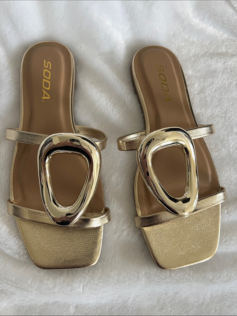 Gold slip on sandals with metal accents, size 5.5